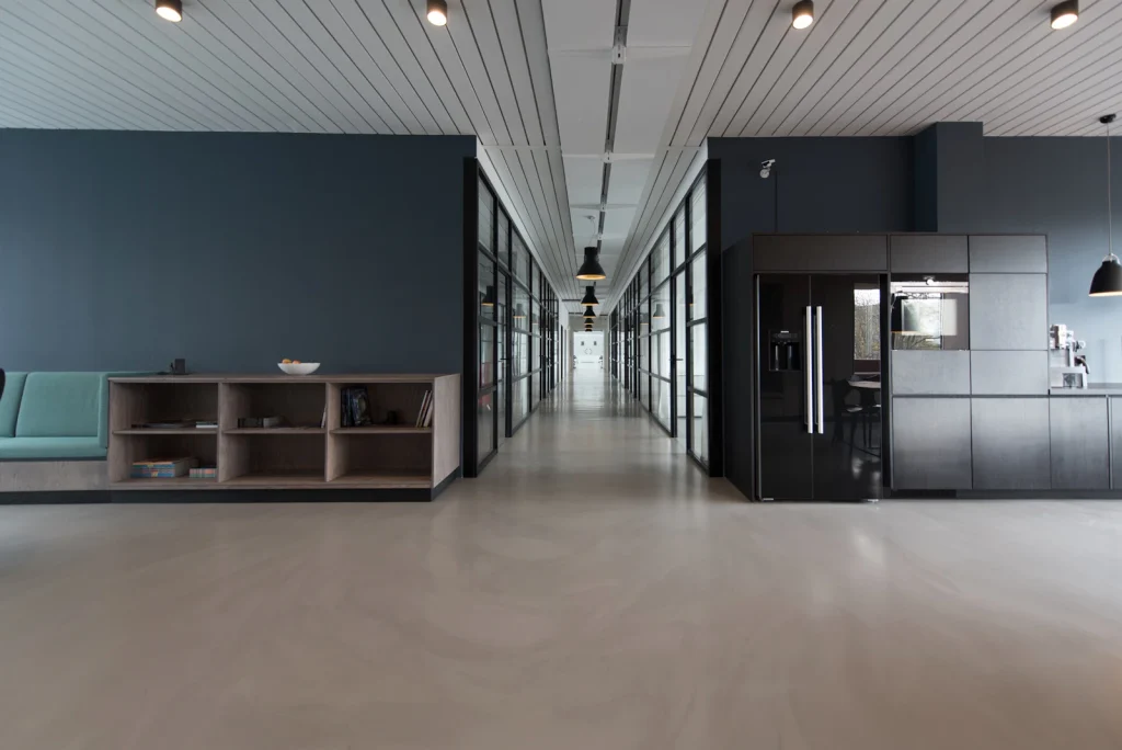 Modern coworking interior with wooden desks and warm lighting